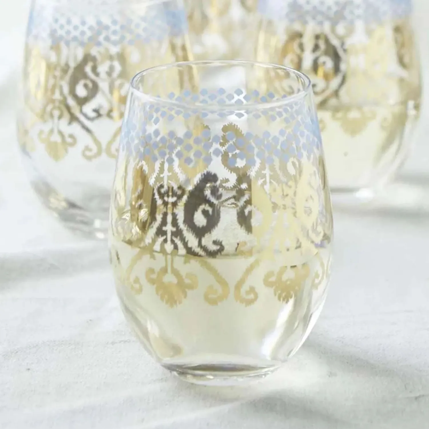 golden_ikat_stemless_glass_1.webp Golden Ikat Stemless Glass>Roger's Gardens Shop